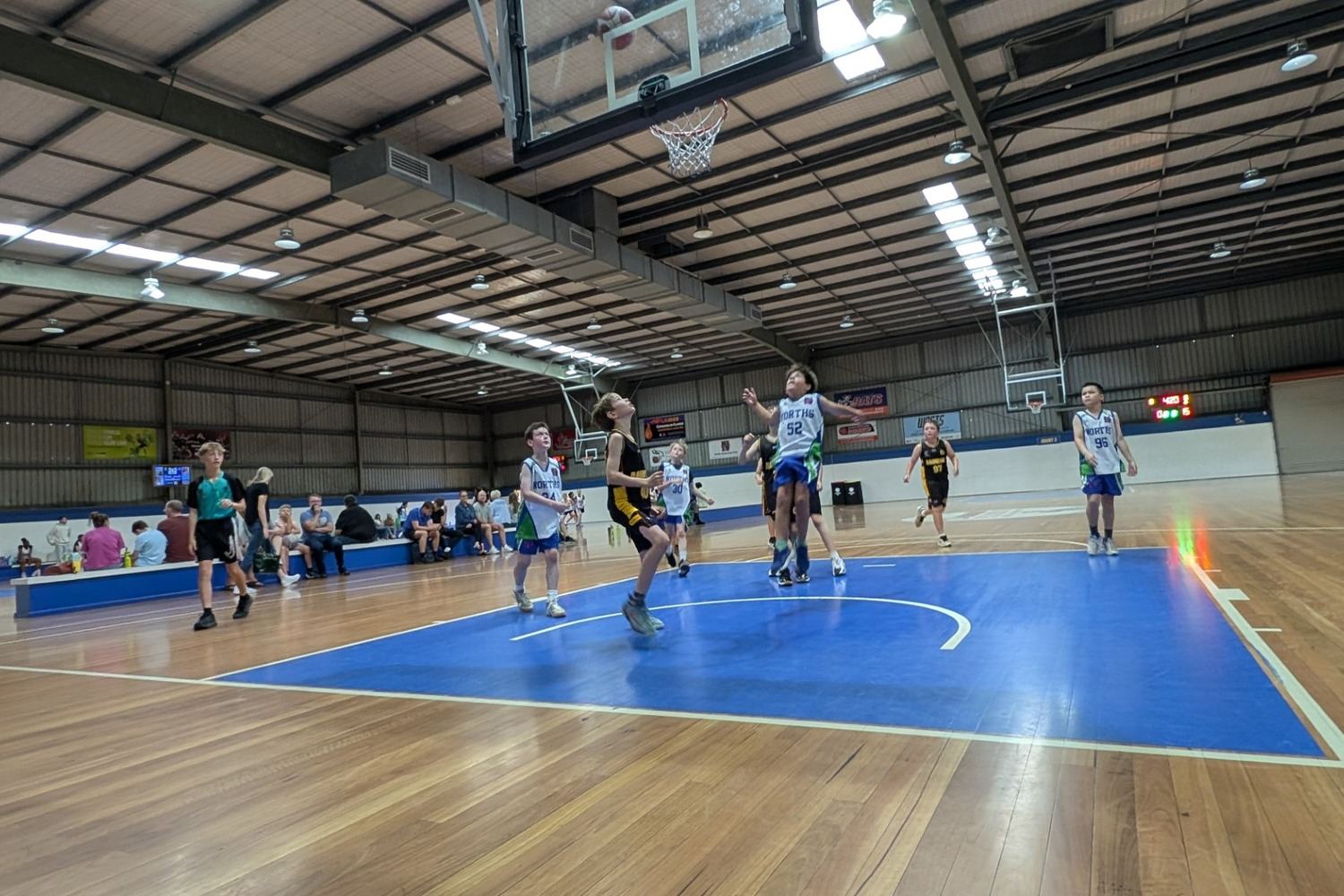 A young Ramblers player drives to the basket during a junior game