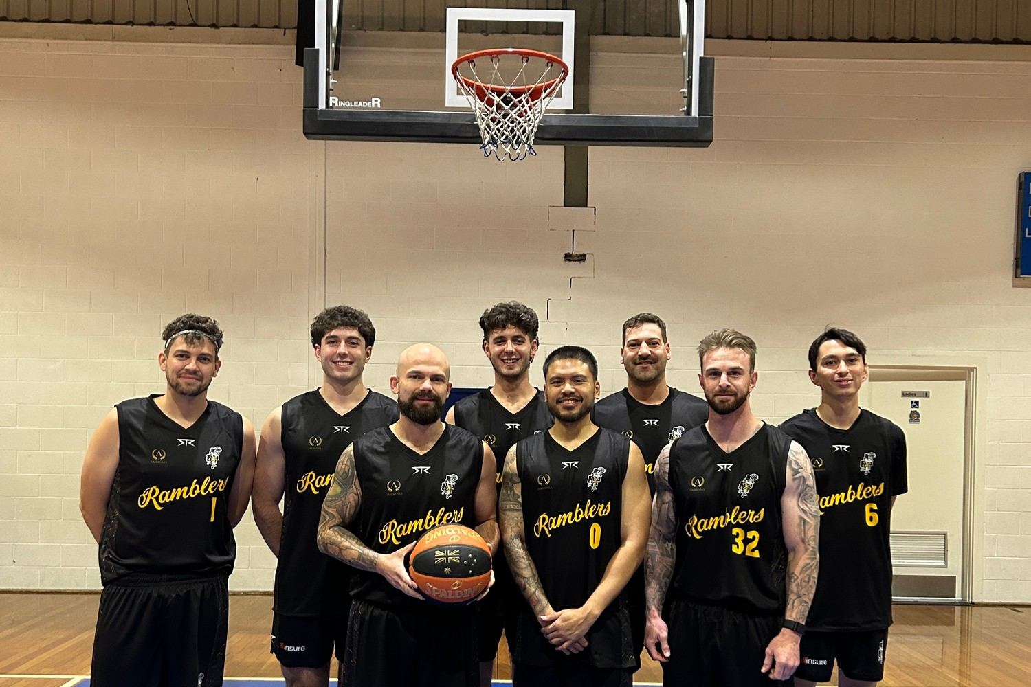 The Ramblers senior men's team posed together under the ring before a game